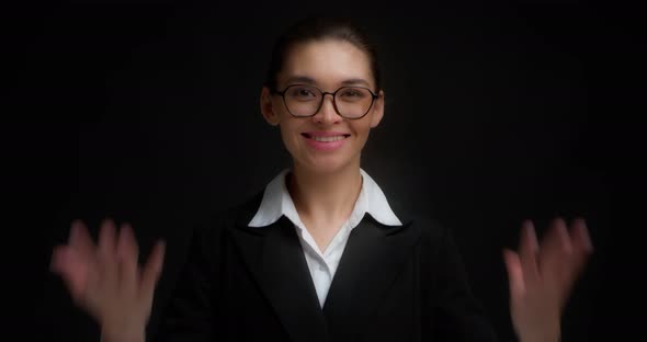 Asian Woman in Glasses Smiling and Shows Eight Fingers with Her Right Hand