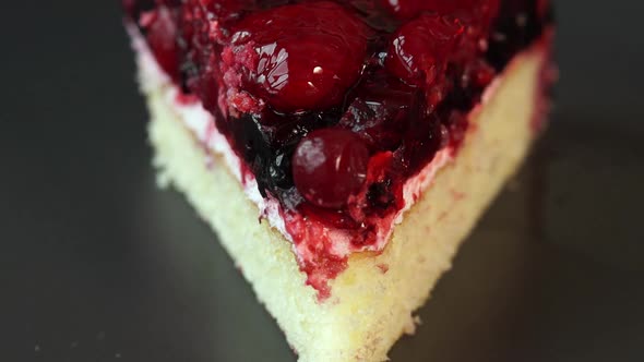 Close Up of Piece of Cake with Red Berries Rotates on Plate