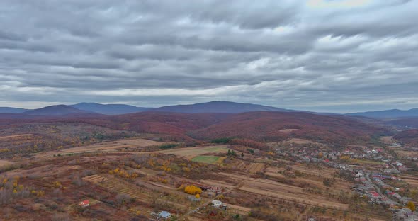 Agricultural Land From a Height in the Valley Near the Mountains on a Overcast Autumn Morning alt