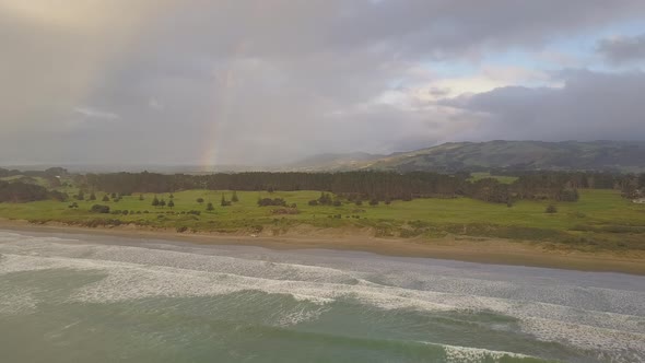 Coast with rainbow and stormy clouds