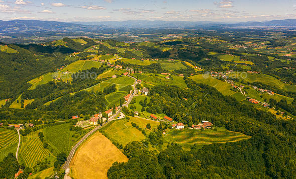 Aerial view of green hills and vineyards with mountains in background. Austria vineyards landscape - Stock Photo - Images