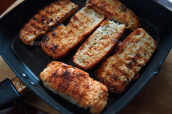 The crispy seared bread in the skillet Stock Photo by Studio_OMG ...
