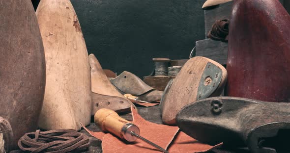 Traditional cobbler workplace with tools, strap, leather and rules. alt