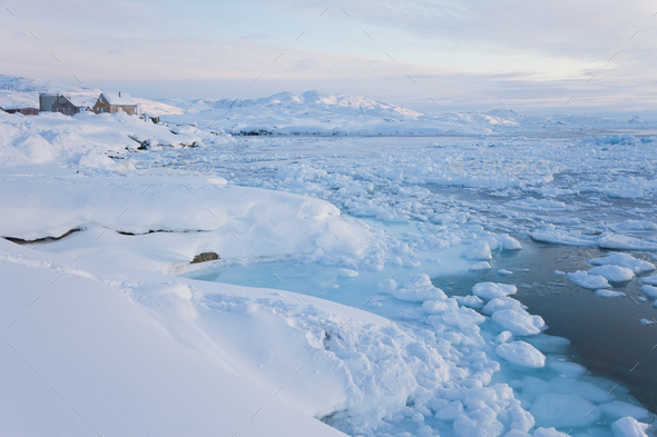 Winter landscape with ice sheets floating on the ocean surface.