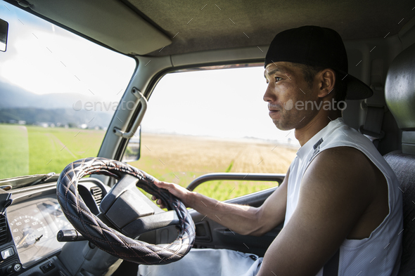 Portrait of Japanese farmer sitting in his tractor.
