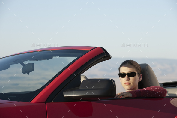 A young Caucasian woman in a convertible sports car. - Stock Photo - Images