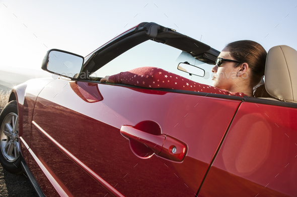 A young Caucasian woman in a convertible sports car. - Stock Photo - Images