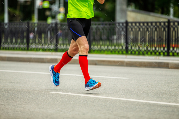 male runner in bright red compression socks