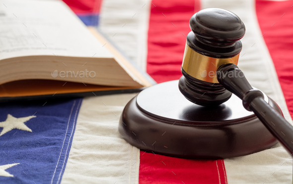 Law gavel and book on United States of America flag.