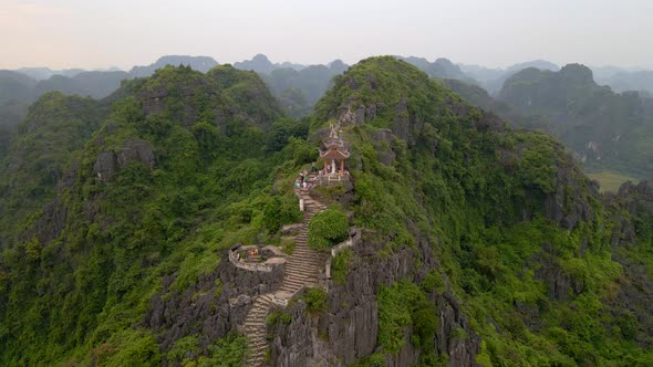 Aerial Shot of the Small Temple and a Dragon on the Top of Marble Mountain Mua Cave Mountain in Ninh alt