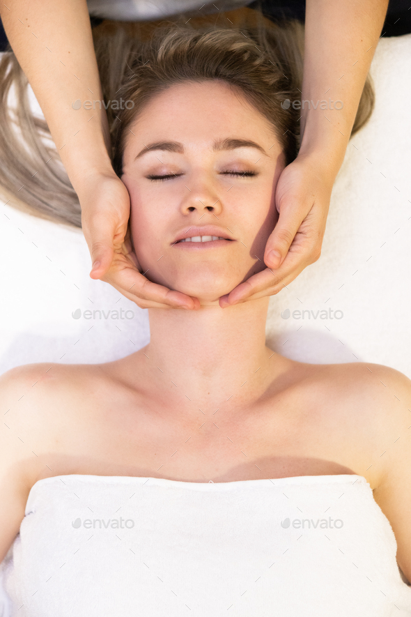 Young woman receiving a back massage in a spa center stock photo