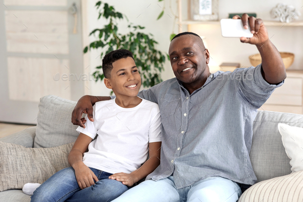 Bonding With Grandchildren. Happy Black Grandpa Taking Selfie On Smartphone With Grandson