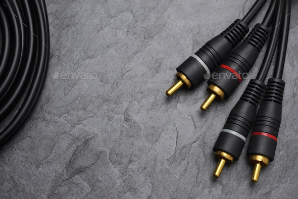 RCA connector for audio signal on black slate background.