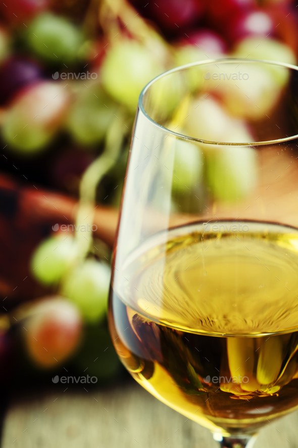 White wine in a glass with fall grapes