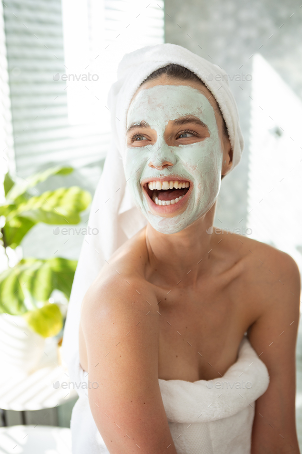 Woman with face pack smiling