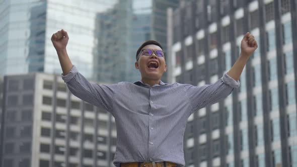 Portrait handsome Asian businessman after a working have success and achievement.