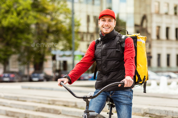 Delivery Guy Smiling To Camera Posing With Bicycle In City