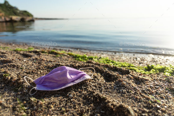 Wasted Medical Mask Lying On Beach Near Water, Ecology Background