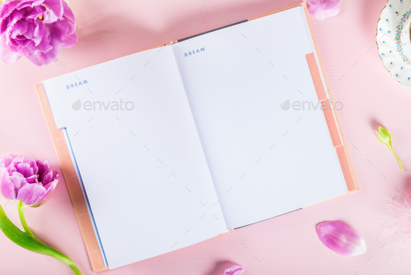 Open Notebook for writing Dreams and Ideas with flowers nearby