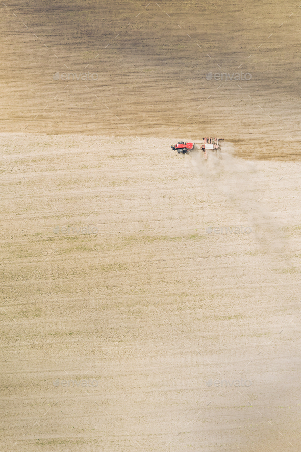 Aerial View. Tractor With Seed Drill Machine Sowing The Seeds For Crops In Spring Season. Beginning - Stock Photo - Images