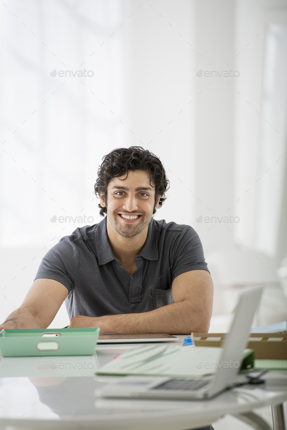 Premium Photo | Serious businessman poses in office at desktop makes phone  call concentrated at laptop display makes notes in diary plans working  schedule dressed in formal clothes being busy. digital management