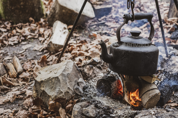 Camping kettle over burning campfire. Stock Photo