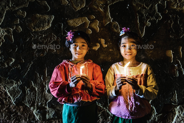 55053,Asian girls holding candles in temple