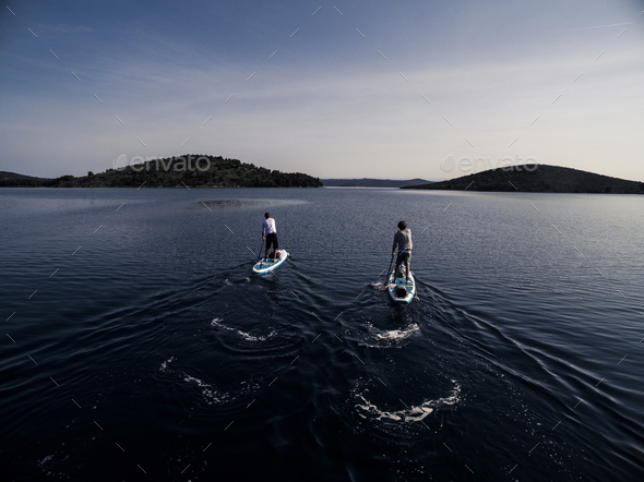 High angle shot of two people on paddleboards.