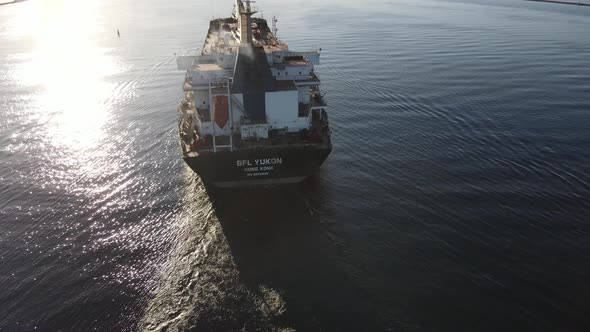 Cargo ship leaving harbor alt