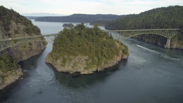 Aerial Film Of Boat Traveling Under Deception Pass Bridge alt