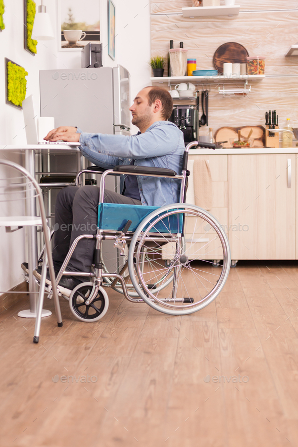 Handicapped businessman in wheelchair - Stock Photo - Images