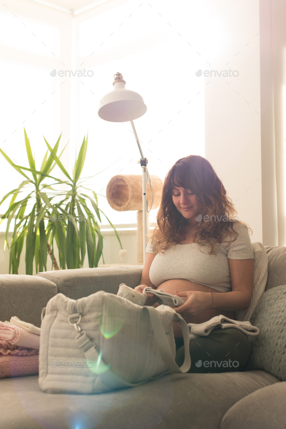 Pregnant woman packing maternity bag