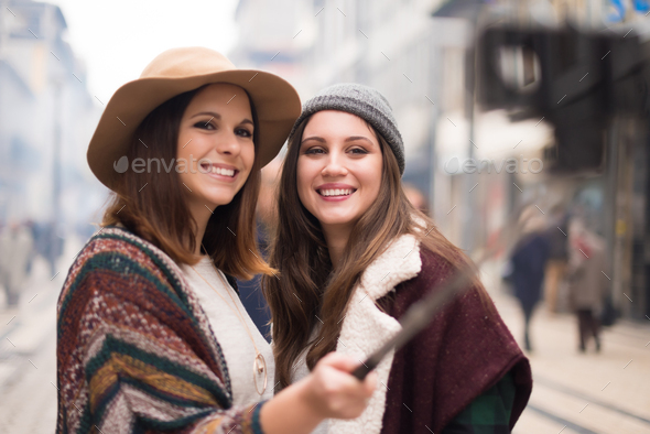 Women taking selfies Stock Photo by TrendsetterImages | PhotoDune