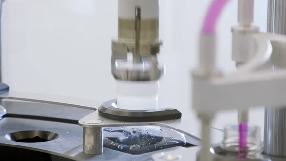 Automated pharmaceutical manufacturing line, bottles filled with liquid alt