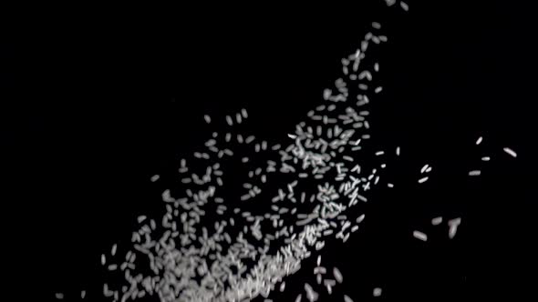 White Rice Flies Up on a Black Background. Slow Motion Video. Food Video White Rice alt
