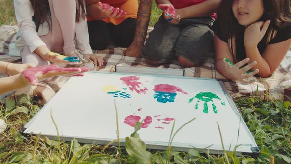 School Children Rejoicing During Outdoor Drawing Lesson with Teacher alt