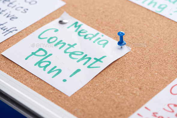 Paper Card With Media Content Plan Inscription Pinned on Cork Office Board