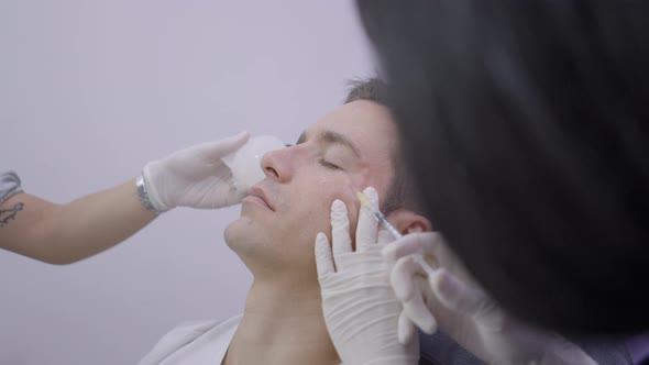 Handsome Man Getting Mesotherapy Treatment in Beauty Salon in Bangkok alt