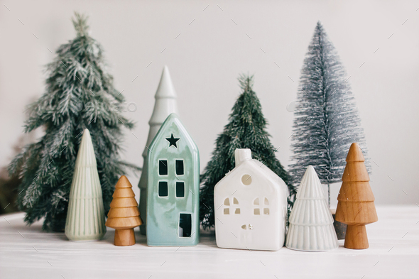 Happy holidays. Miniature cozy village, ceramic houses, wooden and handmade christmas trees