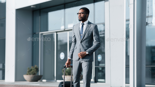 Confident Black Entrepreneur Leaving Airport Arriving On Business Journey, Panorama
