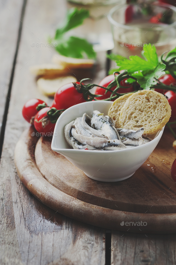Italian traditional anchovy with bread and tomato Stock Photo by OxanaDenezhkina