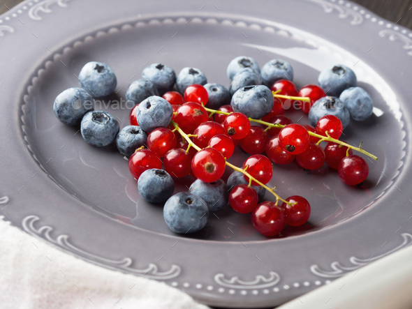 Fresh summer wild berries on rustic plate