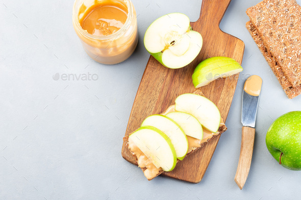 Sandwich with cracker, green apple and peanut butter, copy space