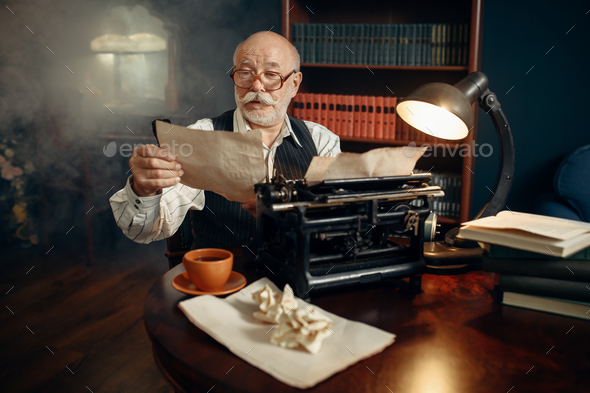 Elderly writer works on vintage typewriter