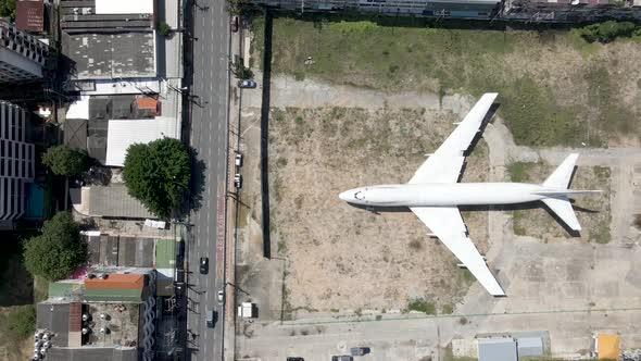 White Plane Emergency landing in the middle of a city, aerial fly over abandoned plane alt