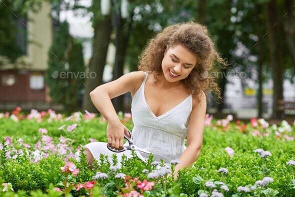 Attractive young woman working at her garden