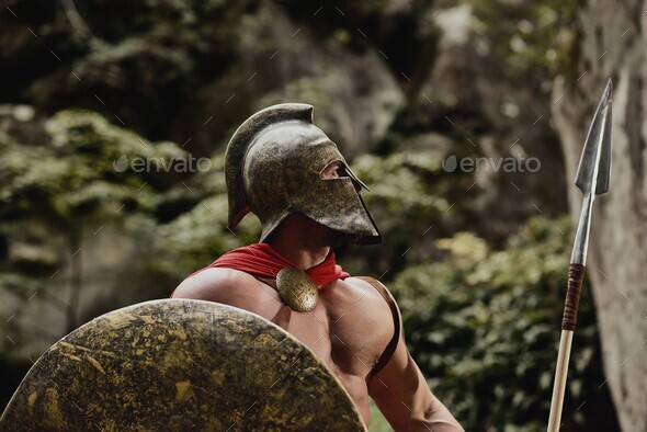 Gladiator in helmet posing with arms