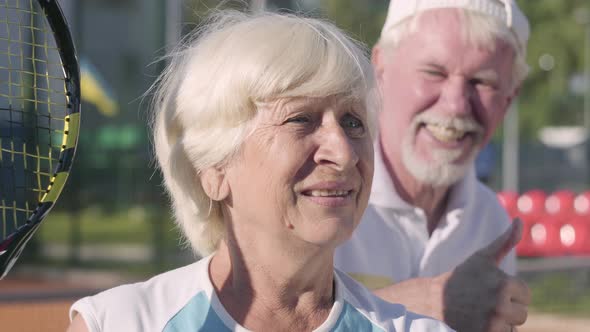 Portrait Mature Couple Playing Tennis on a Sunny Day alt