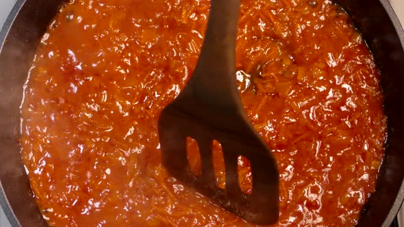 Liquid Red Dish Boils in a Pan