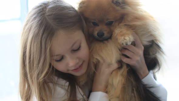 Cute Child Playing with His Dog Friend on the Window